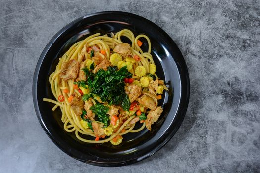 Hot and spicy chicken spaghetti, topping with crispy sweet basil and sliced baby corn
