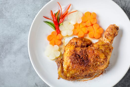 Hot and spicy baked chicken on white plate
