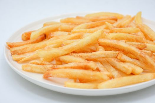 French fries on white dish and white background.