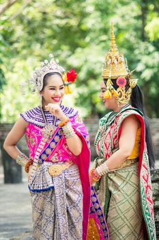 Asian woman wearing typical, traditional Thai Dress. It is literally means "Thai outfit", National costume.
