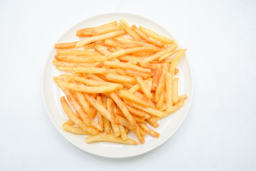 French fries on white dish and white background.