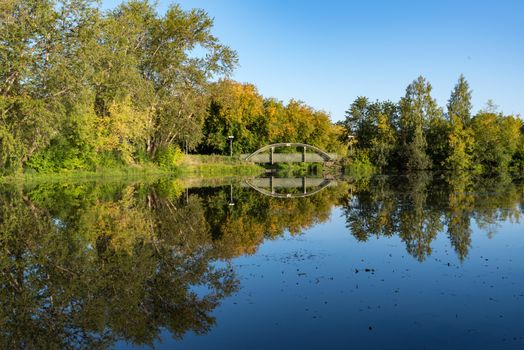 Zakharyevsky park, a bridge across the Tabora pond, next to Tikhvin Assumption (Bogorodichny Uspensky)  Monastery. Leningrad region. Russia