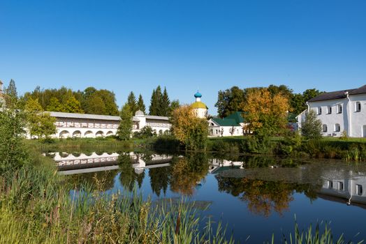 View from pond to Church of the Icon of the Mother of God of All Mourners Joy (Krylechko (Porch) church)  and wall of the Tikhvin Assumption Monastery, Russia