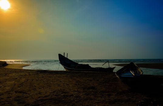 Traditional colorful fishing boat anchored at the confluence of Mahendra Tanaya river and Bay of Bengal, copy space