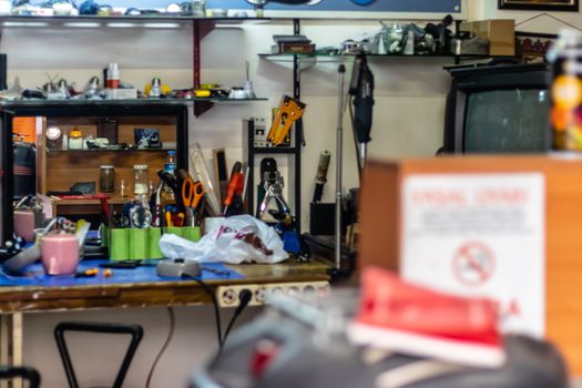 a vintage tinker shop with many tools and blur on foreground. photo has taken at izmir/turkey.