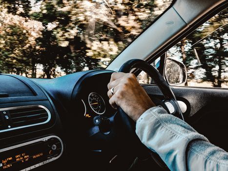 Man in righthand drive car wearing seatbelt