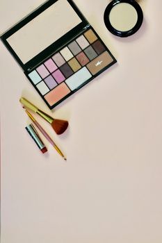 Woman makeup set on the pink background