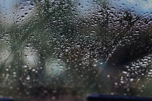 Raindrops on the windshield, blurry scenes