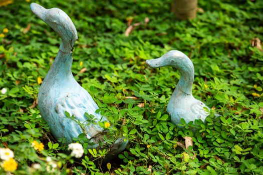 2 Ducks statue decorated in green garden, Selective focus in green garden, Selective focus