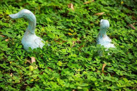 2 Ducks statue decorated in green garden, Selective focus in green garden, Selective focus