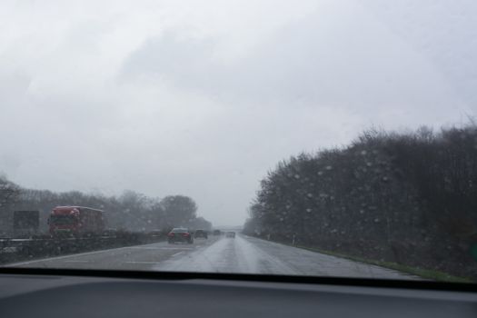 Traffic jam on rainy bad day, raindrops on car window