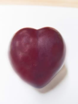 Isolated cherry. Sweet cherry fruits in the shape of a heart, isolated on white background.