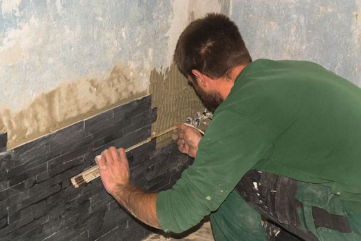 Workers install ceramic retro effect brick tiles