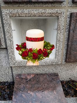 A stone columbarium with open niche and urn