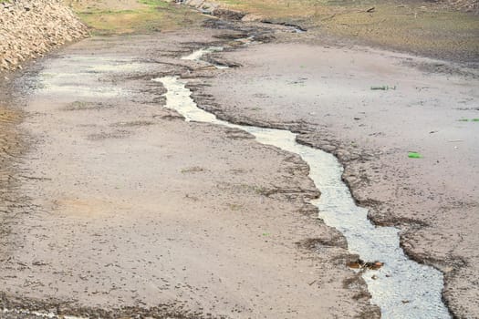 Dried and cracked soil in a dried-up riverbed