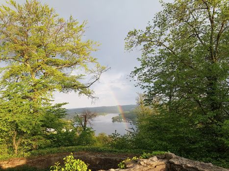 Beautiful rainbow over the castle ruin Isenburg at Baldeneysee in the city Essen