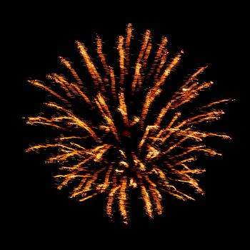 Orange flash and sparks from fireworks isolated on black background.