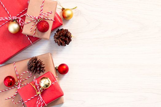 Preparing for the holiday - gift wrapping in red and beige wrapping paper.