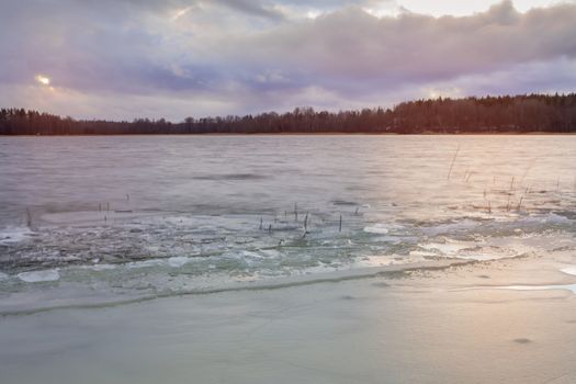 first ice on the lake in late autumn. Winter Coming Landscape.