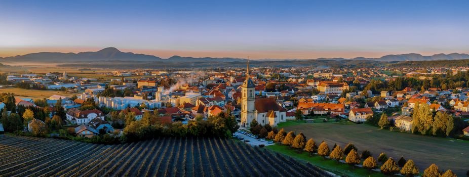 Aerial Panorama view of small medieval european town Slovenska Bistrica, Slovenia with church and castle in sunrise