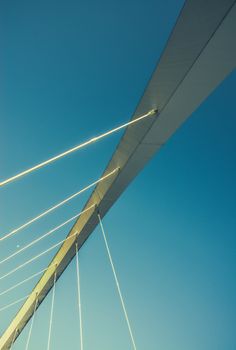 Abstract Architectural Detail Of A Span Of A Suspension Bride With Blue Sky And Copy Space