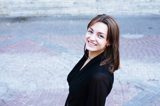 Beauty young woman against nice gray pavement background