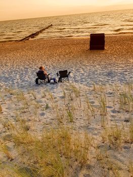 Rear view of a woman on the beach in a deck chair