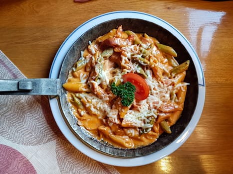 Pasta dish with fresh tomato sauce, mozzarella and basil