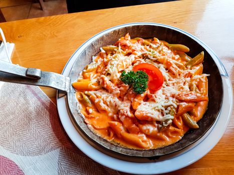 Pasta dish with fresh tomato sauce, mozzarella and basil