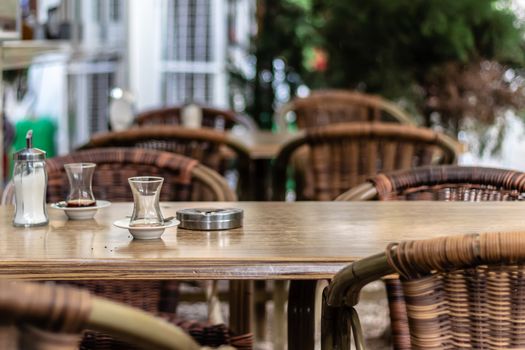 a shoot from a cafe there is some traditional tea glasses and wooden table. photo has taken from izmir/turkey.