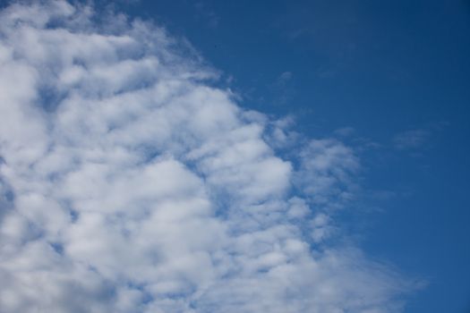 blue sky background with tiny clouds.