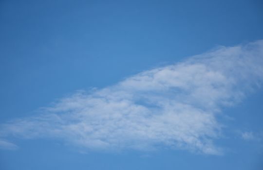 blue sky background with tiny clouds.