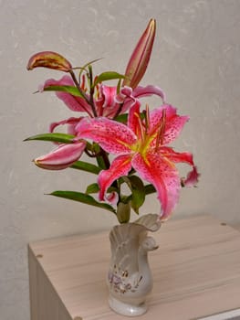 Bouquet of pink flowers in vase isolated on white background