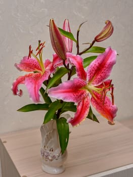 Bouquet of pink flowers in vase isolated on white background