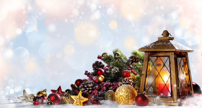 Burning candles , lantern and christmas decoration on glowing bokeh background