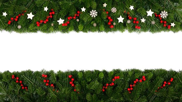 Christmas Border frame of tree branches on white background with copy space isolated, red and white decor of berries stars and snowflakes