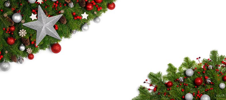 Christmas Border frame of tree branches on white background with copy space isolated, red and silver decor, berries, stars, cones