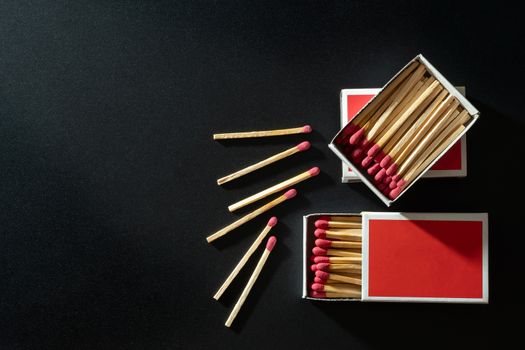 Box matches stick in red paper box on black background. Top view and copy space.