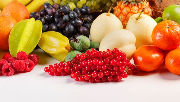 Fresh tropical fruits harvest pile isolated on white background with copy space for text