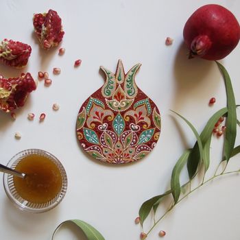Rosh Hashanah Concept (Jewish New Year). Traditional symbols - pomegranate, honey and handmade pomegranate, made from wood, painted with acrylic colors. Top view