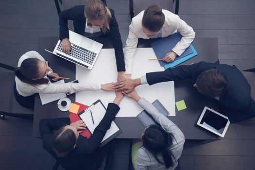 People with their hands together, stacking hands. Business team work concept