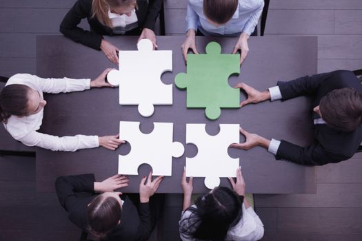 Group of business people assembling jigsaw puzzle, team support problem solution and help concept