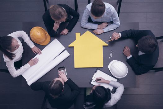 Top view of people around table in construction business meeting
