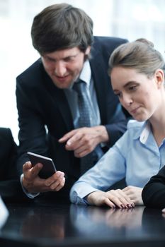 Group of business people working at office and using smartphone