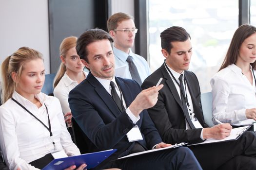 Audience of business people at conference hall