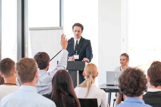 Business people at conference asking questions