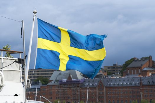 Stockholm, Sweden. September 2019. the Swedish flag waving on a boat