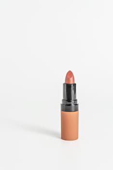 close up orange color lipstick on white background