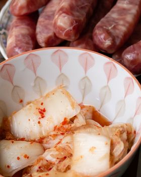 Korean kimchi and Taiwanese sausage in bowls