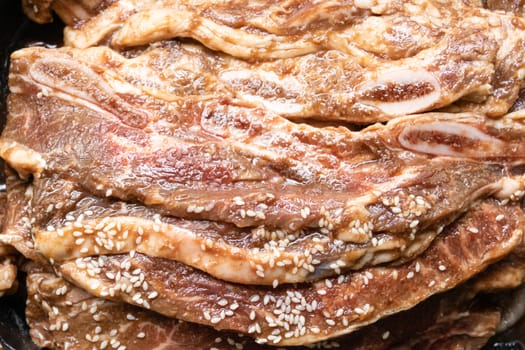 Bowl with stack of raw beef rib steaks